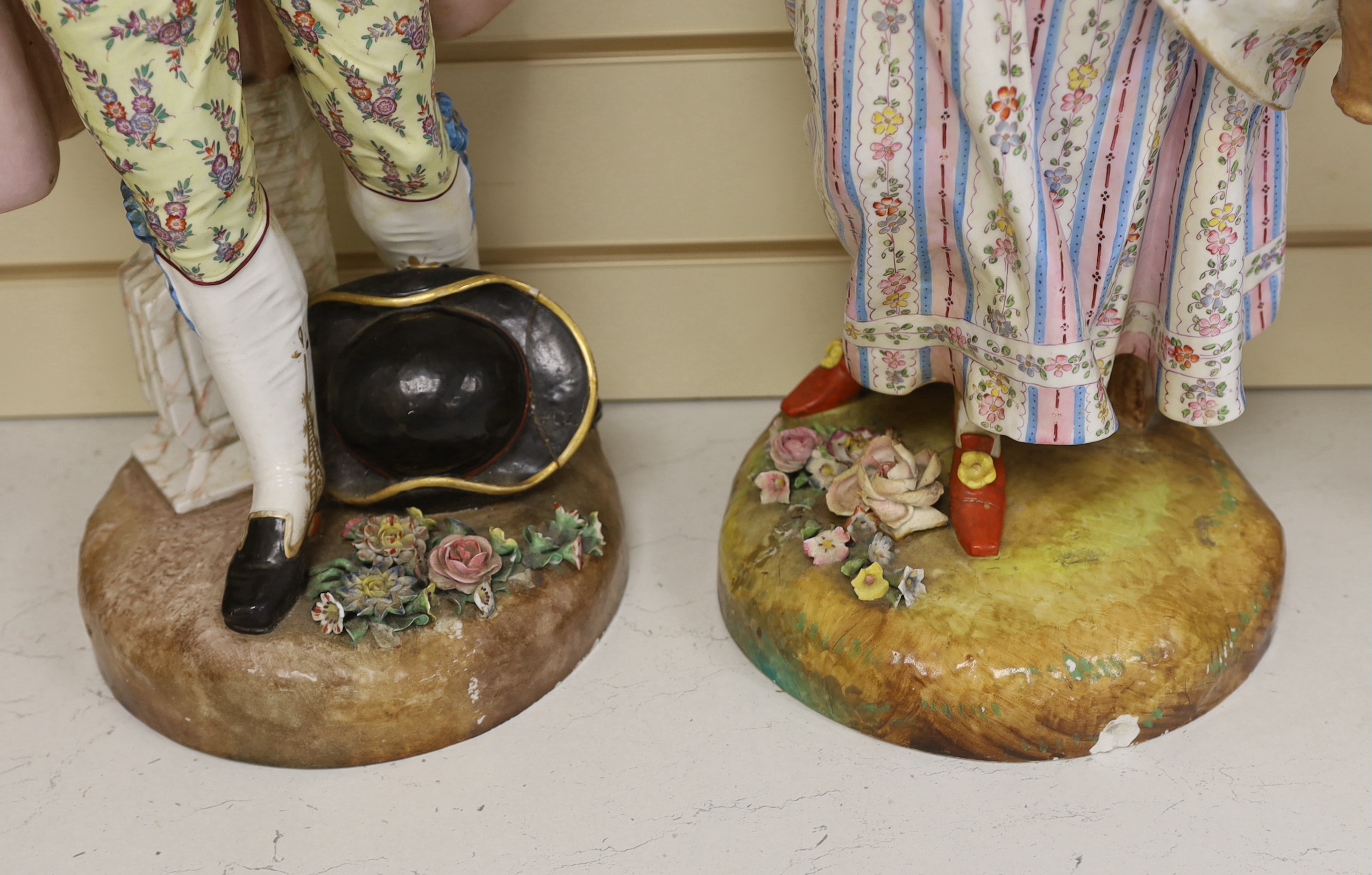 A pair of massive German porcelain figures of flower sellers, late 19th century, 66.5cm